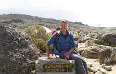Sitting on a sign post on the 6 day Rongai Route