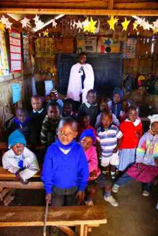 School and the teacher all in for a group photo School and the teacher all in for a group photo